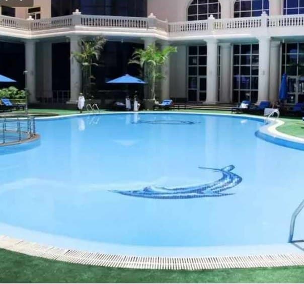 Outdoor pool framed by the hotel colonnade